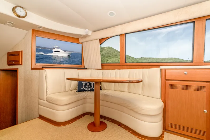 Dieguito Yacht Photos Pics Interior of 2004 Cabo 48 Flybridge yacht with plush seating and ocean view.