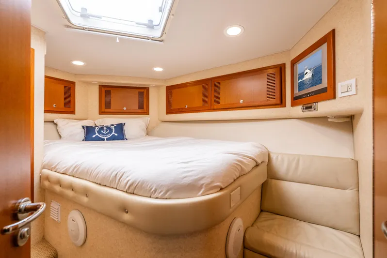 Dieguito Yacht Photos Pics Luxurious cabin interior of 2004 Cabo 48 Flybridge yacht with cozy bed and seating.