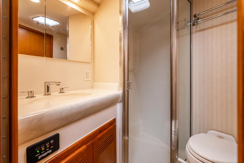 Dieguito Yacht Photos Pics Luxurious bathroom in 2004 Cabo 48 Flybridge yacht with modern fixtures and shower.