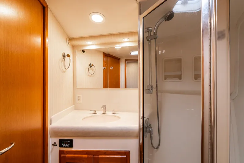 Dieguito Yacht Photos Pics Bathroom interior of 2004 Cabo 48 Flybridge yacht with shower and vanity.
