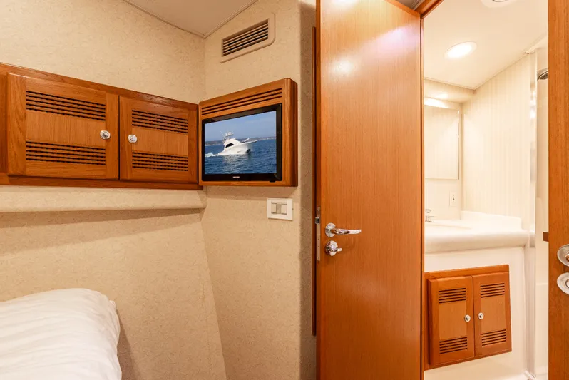 Dieguito Yacht Photos Pics Interior of 2004 Cabo 48 Flybridge yacht cabin with TV and bathroom.