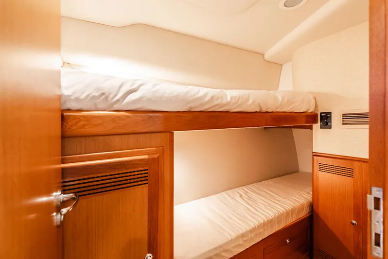 Dieguito Yacht Photos Pics Bunk beds in 2004 Cabo 48 Flybridge yacht cabin with wooden finish.