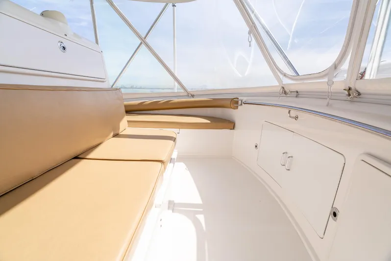 Dieguito Yacht Photos Pics 2004 Cabo 48 Flybridge interior with tan seating and white cabinetry.