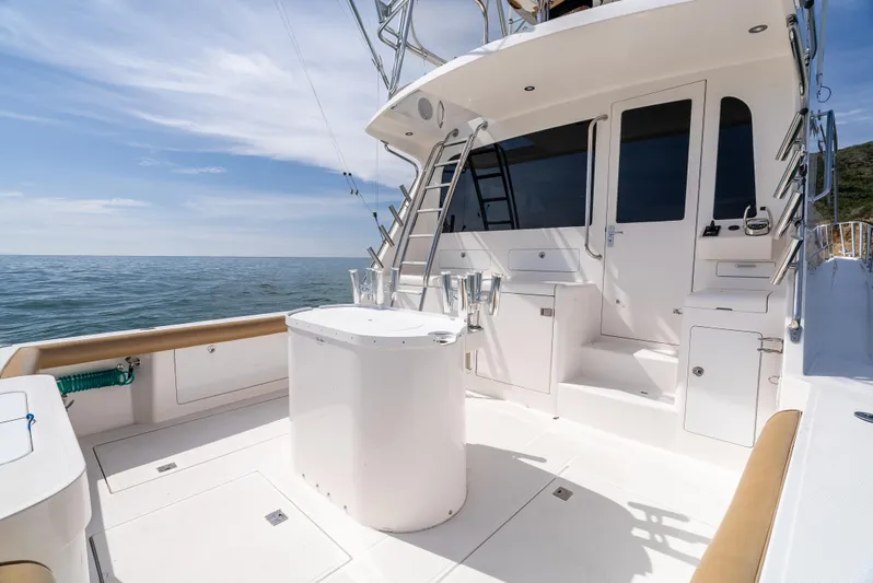 Dieguito Yacht Photos Pics 2004 Cabo 48 Flybridge yacht deck with ocean view and fishing equipment.