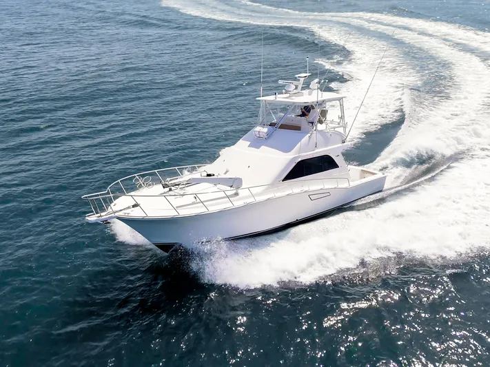 Dieguito Yacht Photos Pics 2004 Cabo 48 Flybridge yacht cruising on open water, creating a dynamic wake.