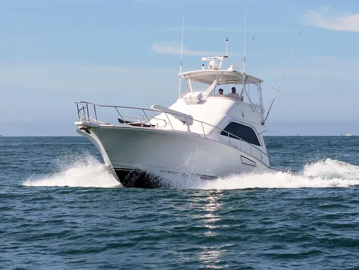 Dieguito Yacht Photos Pics 2004 Cabo 48 Flybridge yacht cruising on open water.