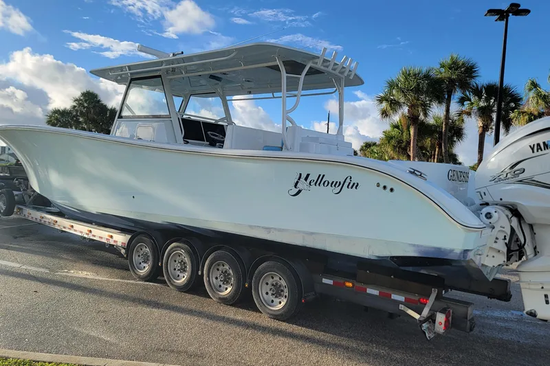  Yacht Photos Pics 2022 Yellowfin 42 Offshore boat on trailer, parked under a clear blue sky.