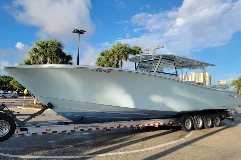  Yacht Photos Pics 2022 Yellowfin 42 Offshore boat on trailer, parked under a clear blue sky.