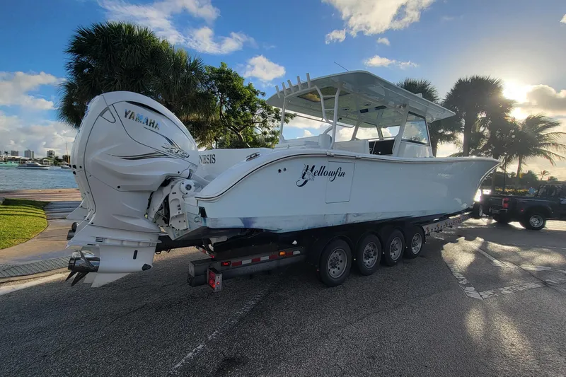  Yacht Photos Pics 2022 Yellowfin 42 Offshore boat on trailer with Yamaha engines, parked near waterfront.