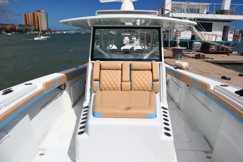  Yacht Photos Pics 2022 Yellowfin 42 Offshore boat with tan seating, docked in a marina.