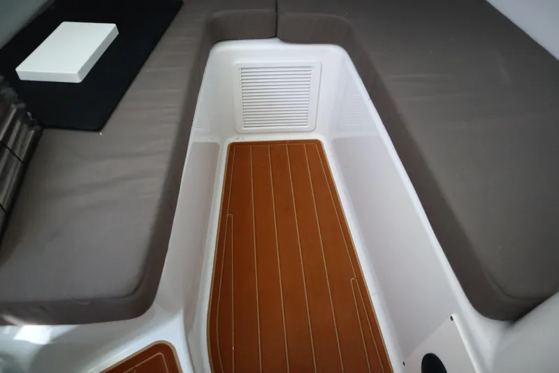  Yacht Photos Pics 2022 Yellowfin 42 Offshore cabin interior with cushioned seating and wood-style flooring.