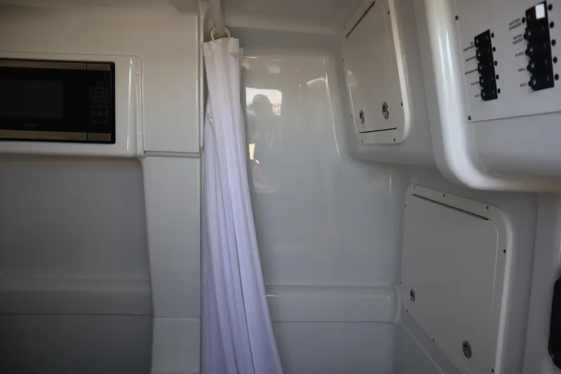  Yacht Photos Pics Interior of 2022 Yellowfin 42 Offshore boat with microwave and control panels.