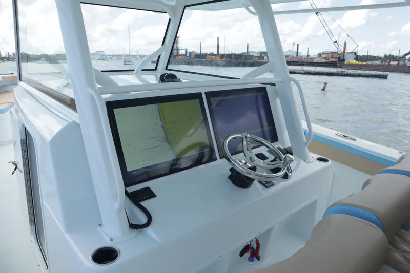  Yacht Photos Pics 2022 Yellowfin 42 Offshore boat dashboard with dual screens and steering wheel.