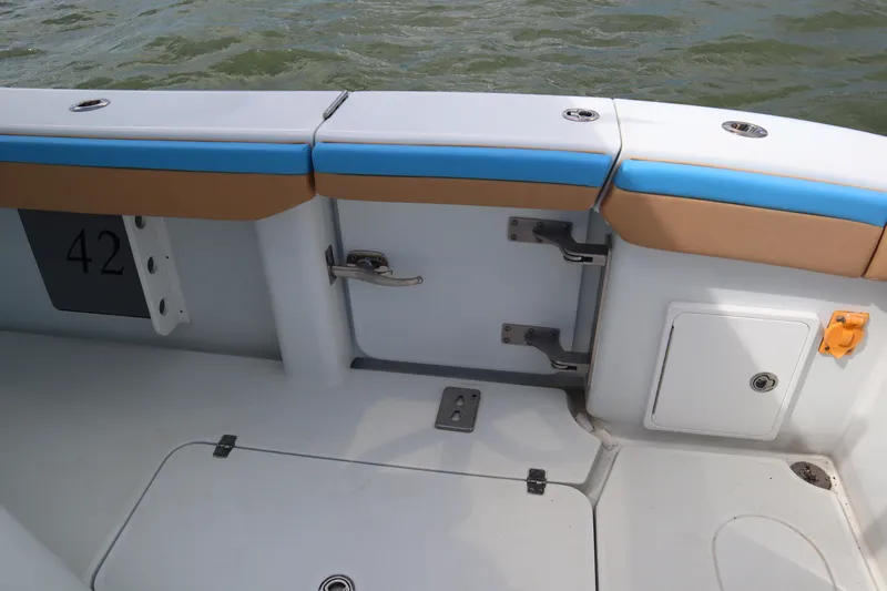  Yacht Photos Pics 2022 Yellowfin 42 Offshore boat interior with seating and storage compartments.