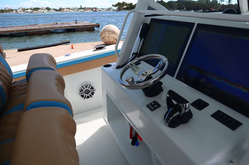  Yacht Photos Pics Interior of 2022 Yellowfin 42 Offshore boat with steering wheel and navigation screens.
