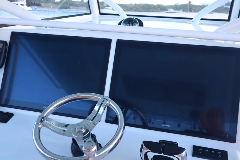  Yacht Photos Pics 2022 Yellowfin 42 Offshore helm with dual Garmin displays and steering wheel.