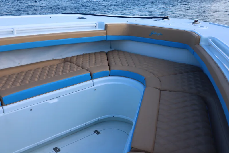  Yacht Photos Pics 2022 Yellowfin 42 Offshore boat interior with tan and blue cushioned seating.