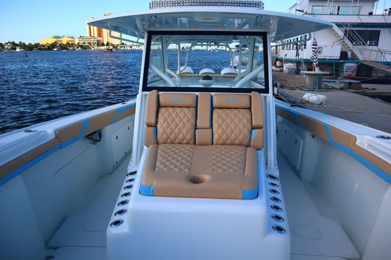  Yacht Photos Pics 2022 Yellowfin 42 Offshore boat with tan seating, docked by the water.