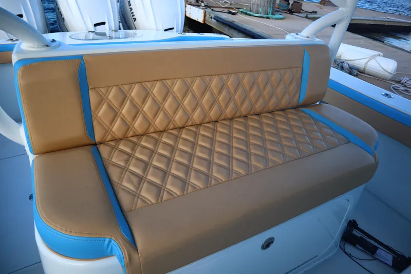  Yacht Photos Pics Luxurious tan and blue seating on 2022 Yellowfin 42 Offshore boat.