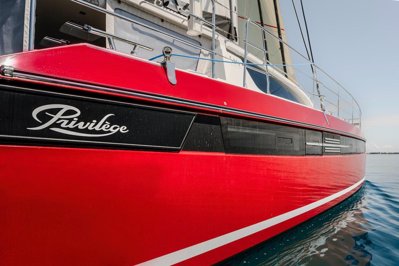 Red Privilege Signature 510 yacht from 2025 on calm water.