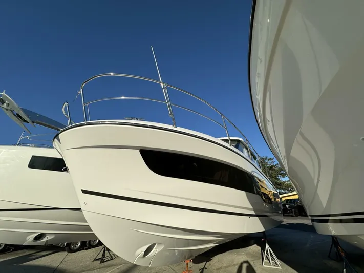  Yacht Photos Pics 2025 Jeanneau NC 1095 Weekender boat on display under clear blue sky.