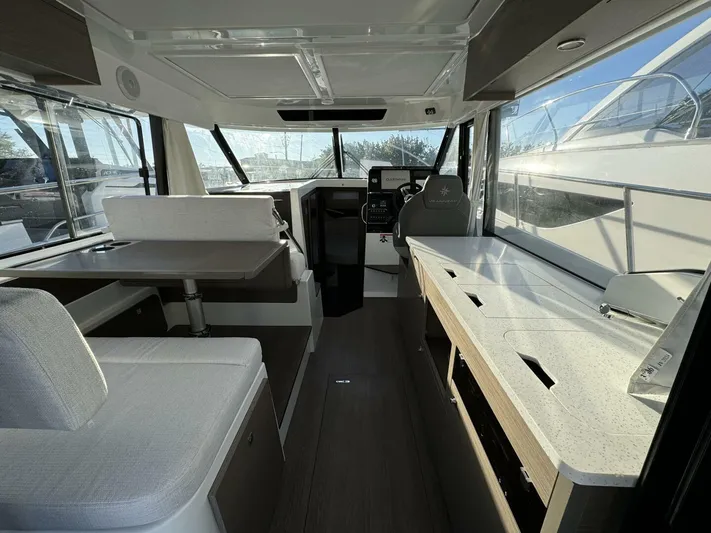  Yacht Photos Pics Interior of 2025 Jeanneau NC 1095 Weekender, featuring modern seating and navigation area.