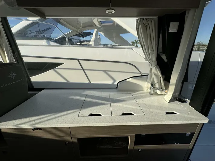  Yacht Photos Pics Interior of 2025 Jeanneau NC 1095 Weekender, featuring a sleek countertop and window view.
