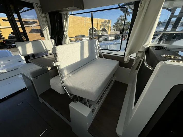  Yacht Photos Pics 2025 Jeanneau NC 1095 Weekender interior with seating and table, showcasing modern design.
