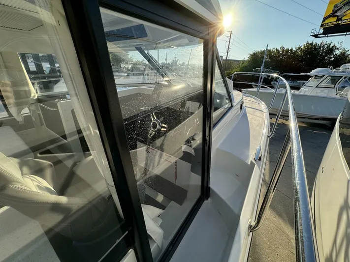  Yacht Photos Pics 2025 Jeanneau NC 1095 Weekender boat, side view with sunlit interior and exterior details.