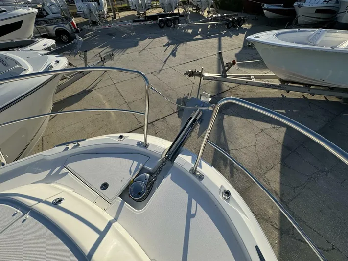  Yacht Photos Pics 2025 Jeanneau NC 1095 Weekender boat bow with anchor and railing in a marina.