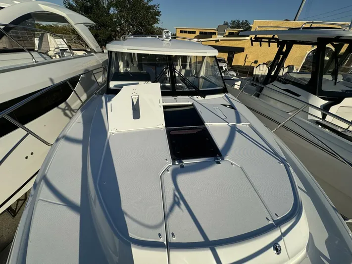  Yacht Photos Pics 2025 Jeanneau NC 1095 Weekender boat, docked, showcasing sleek design and spacious deck.