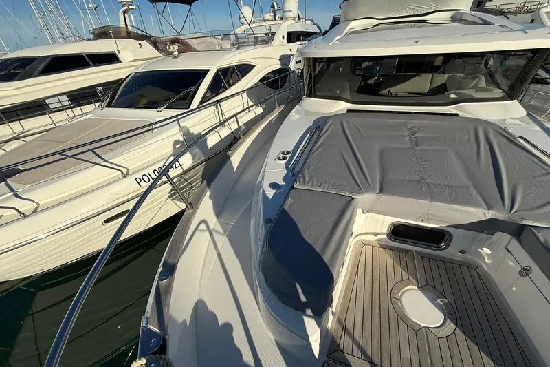 Gbtt Ex Lennartz Yacht Photos Pics 2025 Nimbus 495 Flybridge yacht docked, showcasing sleek design and spacious deck.