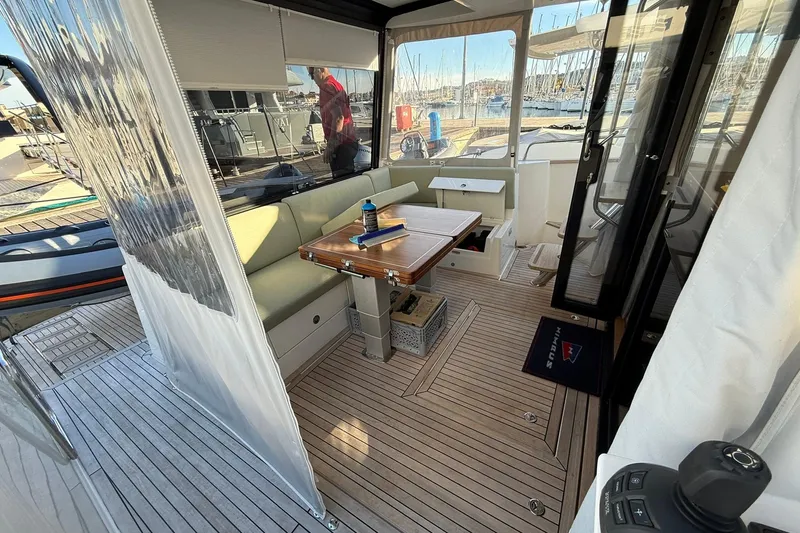 Gbtt Ex Lennartz Yacht Photos Pics Luxurious interior of 2025 Nimbus 495 Flybridge yacht with elegant seating and wooden flooring.