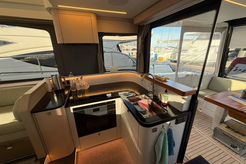 Gbtt Ex Lennartz Yacht Photos Pics Luxurious interior of 2025 Nimbus 495 Flybridge yacht with modern kitchen amenities.