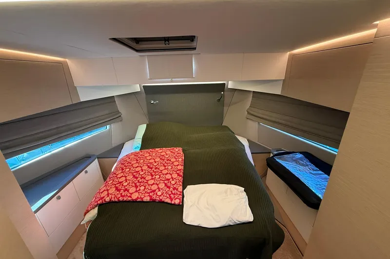 Gbtt Ex Lennartz Yacht Photos Pics Luxurious bedroom interior of 2025 Nimbus 495 Flybridge yacht, featuring modern design and cozy bedding.