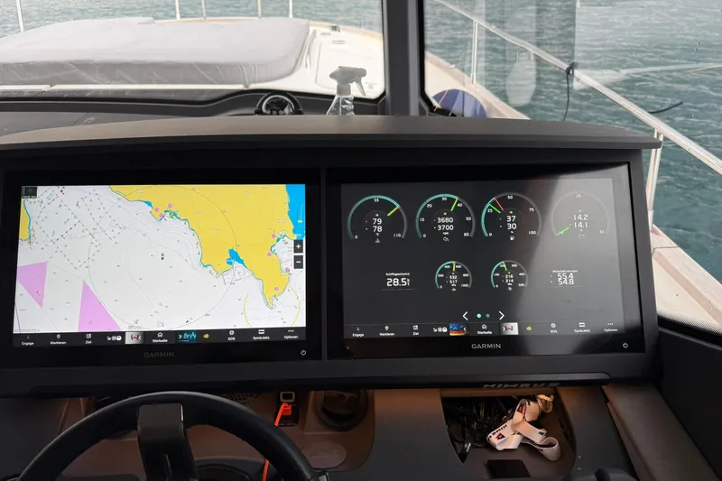 Gbtt Ex Lennartz Yacht Photos Pics 2025 Nimbus 495 Flybridge helm with dual Garmin displays showing navigation and engine data.