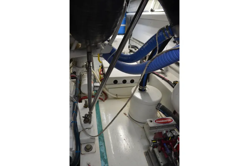 Steel Dreamin Yacht Photos Pics Engine room of 2001 Hatteras 55 Convertible yacht with visible hoses and components.