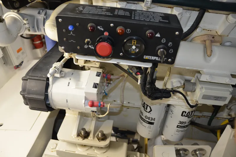 Steel Dreamin Yacht Photos Pics Engine room of 2001 Hatteras 55 Convertible with Caterpillar components and control panel.