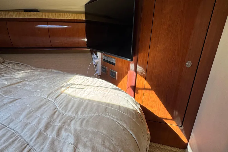 Dream Builder Yacht Photos Pics Interior of 2005 Sea Ray 420 Sundancer with wood paneling and mounted TV.