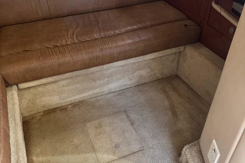 Dream Builder Yacht Photos Pics Interior of 2005 Sea Ray 420 Sundancer with brown leather seating and beige carpet.