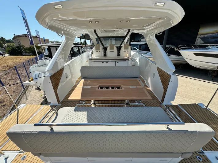  Yacht Photos Pics 2025 Jeanneau DB/37 IB yacht interior with elegant seating and wooden table.