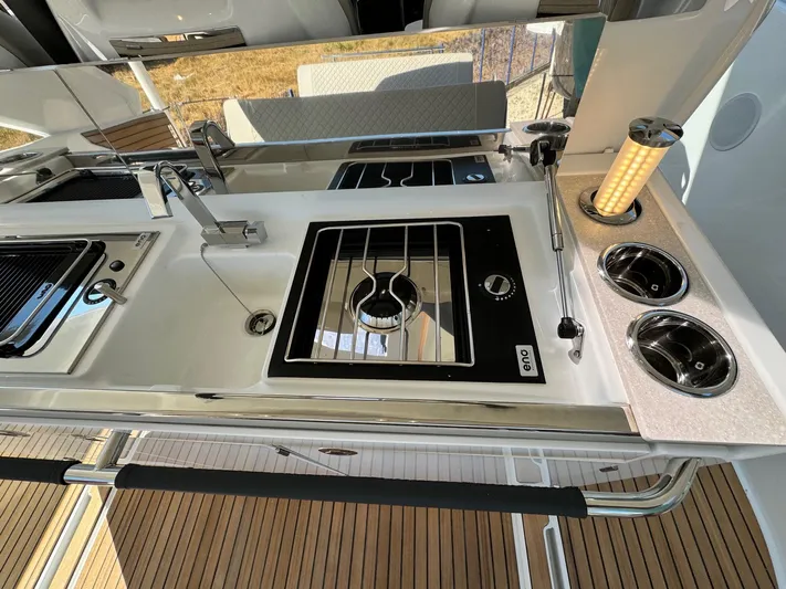  Yacht Photos Pics Modern kitchen area on 2025 Jeanneau DB/37 IB yacht with sleek appliances and fixtures.