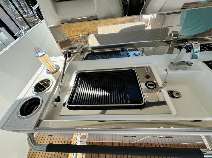  Yacht Photos Pics Outdoor kitchen on 2025 Jeanneau DB/37 IB yacht with grill and sink.