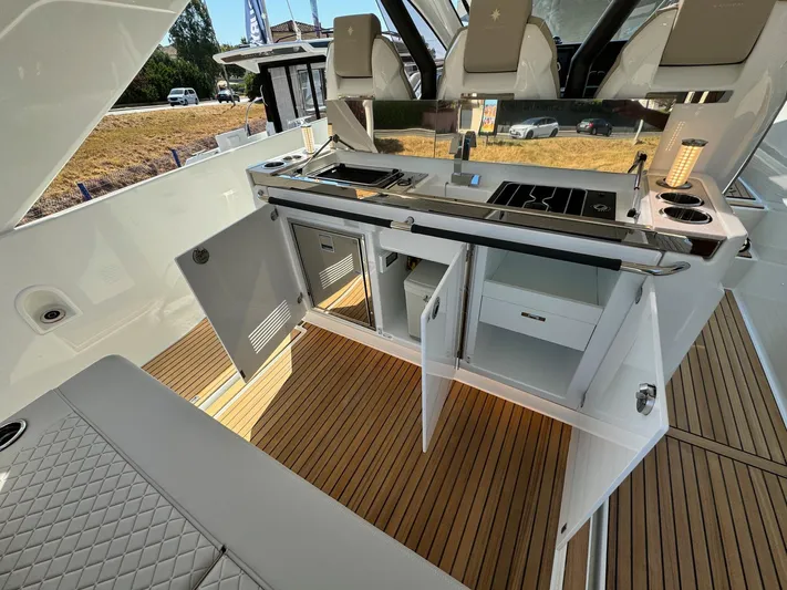 Yacht Photos Pics 2025 Jeanneau DB/37 IB yacht interior with open kitchen cabinets and sleek design.