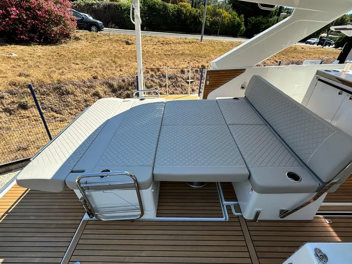  Yacht Photos Pics 2025 Jeanneau DB/37 IB boat with luxurious deck seating and wooden flooring.