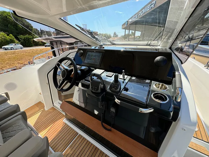  Yacht Photos Pics 2025 Jeanneau DB/37 IB yacht helm with modern controls and sleek design.