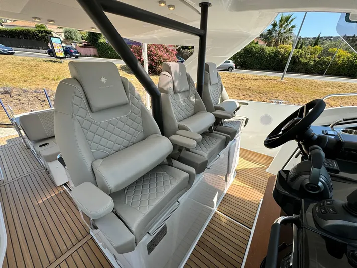  Yacht Photos Pics Luxurious seating and helm of 2025 Jeanneau DB/37 IB boat with elegant design.