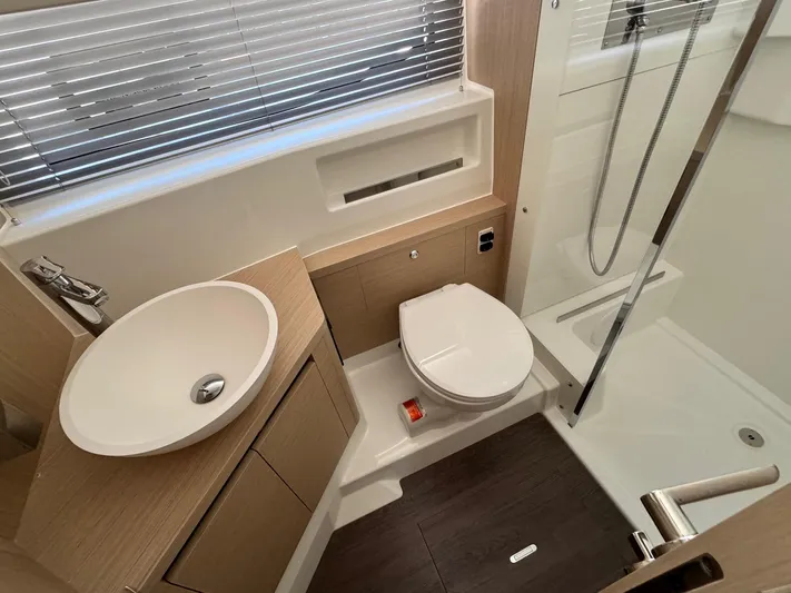  Yacht Photos Pics Modern bathroom in 2025 Jeanneau DB/37 IB yacht with sink, toilet, and shower.