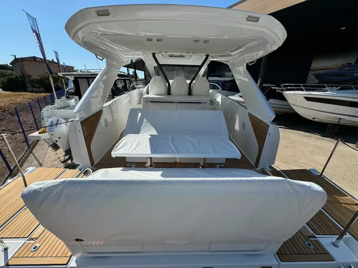  Yacht Photos Pics 2025 Jeanneau DB/37 IB luxury yacht interior with white seating and wooden deck.