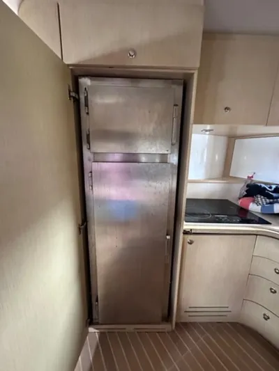 Kore Yacht Photos Pics Stainless steel refrigerator in the kitchen of a 2006 Baia 63 Azzurra yacht.